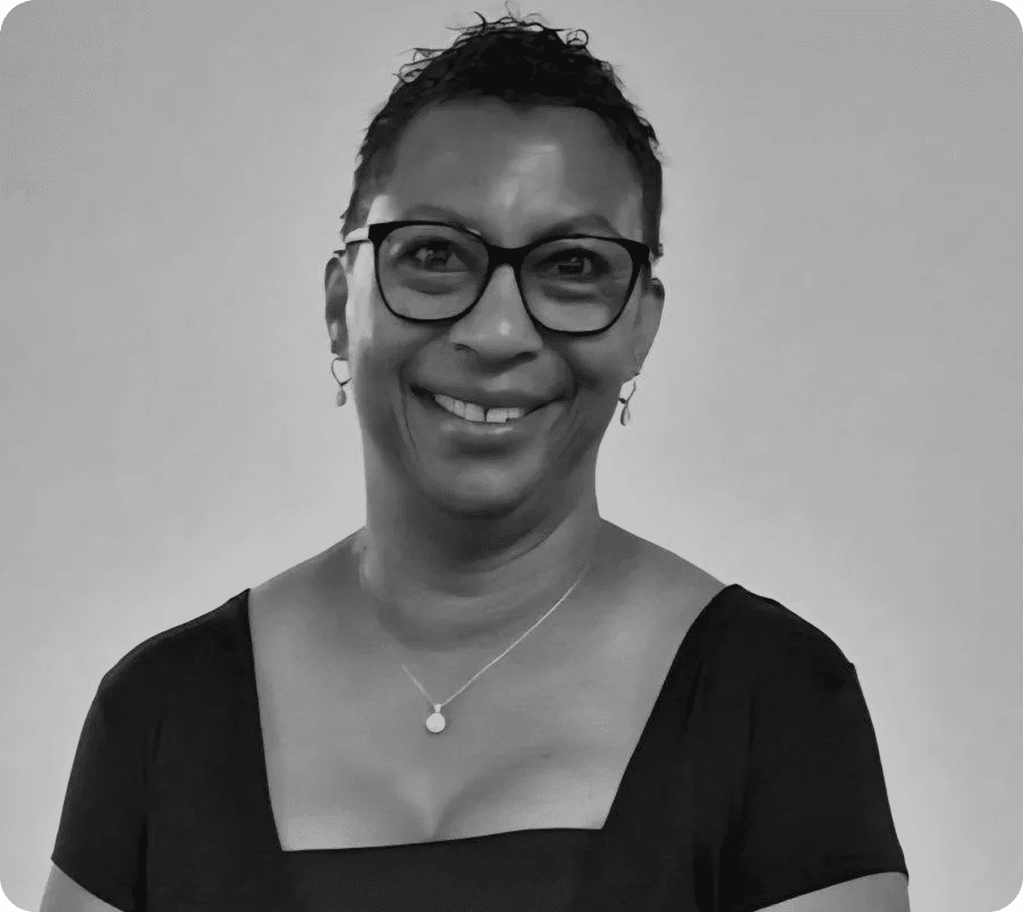 Smiling woman with glasses in grayscale