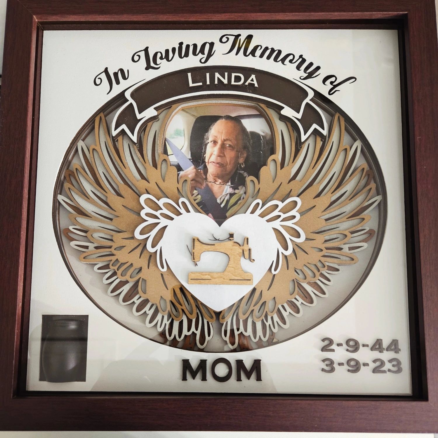 Memorial plaque with photo and dates.
