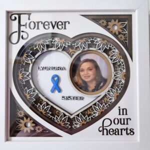 Heart-shaped memorial frame with floral design.