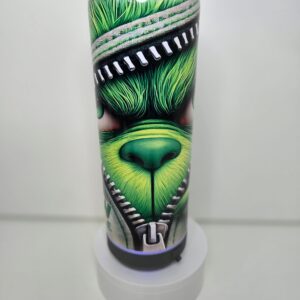 Green character-themed cylindrical object with zipper design.