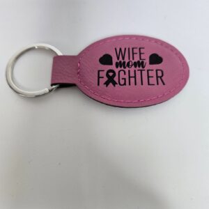 Pink keychain with "Wife Mom Fighter" text.